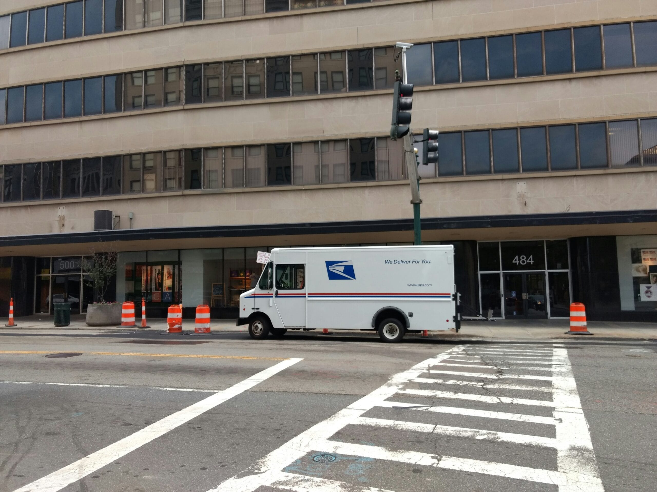 career usps white van near concrete building skill